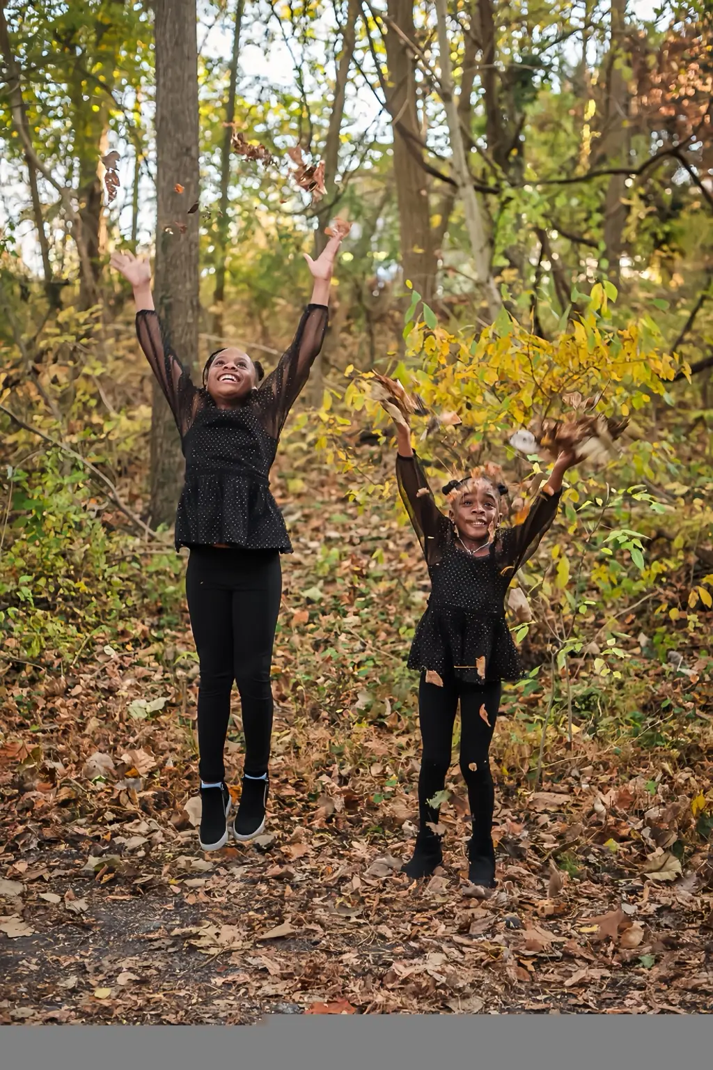Children playing in autumn leaves